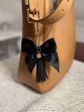 NEW. 🖤 Bag charm or keychain. Faux leather tassel and black satin ribbon charm